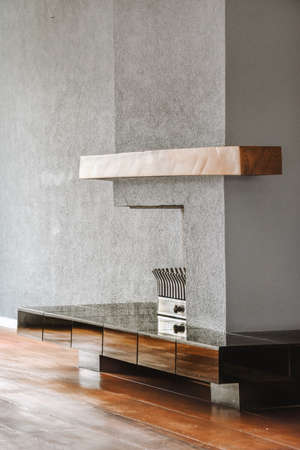 Contemporary fireplace with glass screen installed in gray wall in living room at home