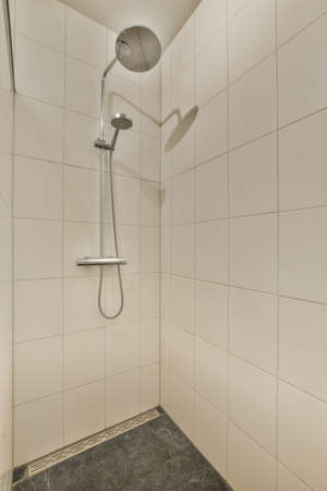 Interior of contemporary bathroom with shower and sink in minimal style in flat