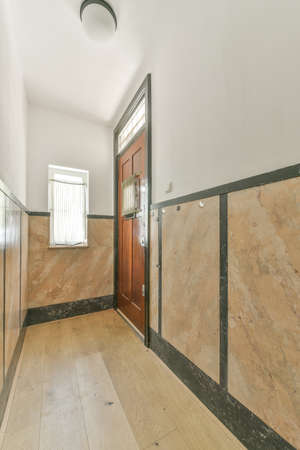 Spacious bright corridor with parquet floor stairs and window in minimalism style