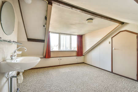 A cozy and spacious empty room with sink and window in a luxury houseの写真素材