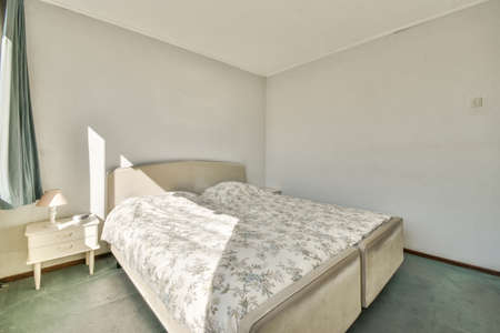 Home interior design of bedroom with bed and wooden wardrobe placed in corner near window in modern...