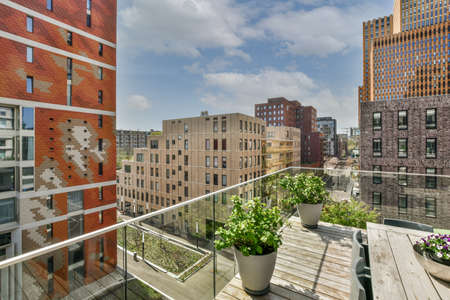 Front view of old brick buildings from small balcony with glass railings