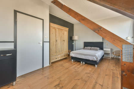 Mansard bedroom with minimalist interior design 47 6 Comfortable bed placed near green wall in...