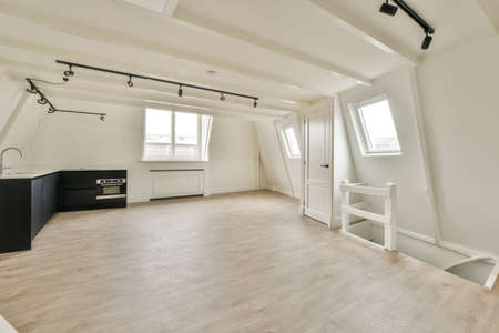 A cozy and spacious mansard styled empty room in a luxury houseの写真素材