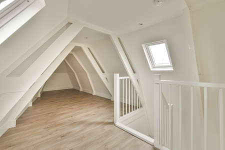A cozy and spacious mansard styled empty room in a luxury house
