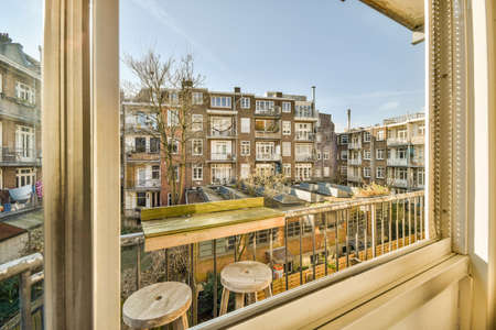 Front view of old brick buildings from small balcony with railings