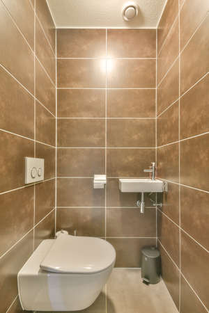 Modern home interior design of white bathroom with open bathtub and shower separated from toilet by...