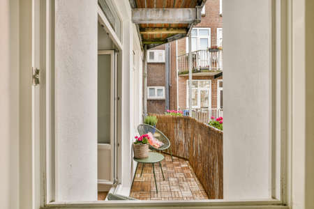 Sitting area in balcony with comfortable furniture around beautiful view