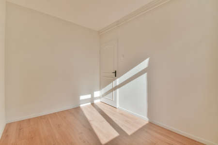 Plastic window and radiator on white wall in empty light room at homeの写真素材