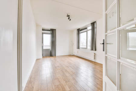 Plastic window and radiator on white wall in empty light room at homeの写真素材