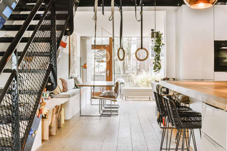 Interior of light kitchen and dining room in contemporary apartment at daytime