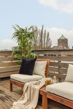 Sitting area in balcony with comfortable furniture around beautiful view