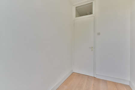 Plastic window and radiator on white wall in empty light room at home