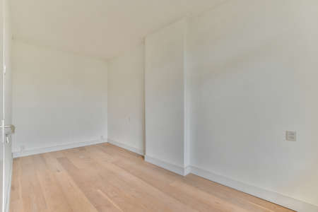 Interior of empty white room with large balcony windows with curtains and wooden parquet floorの写真素材