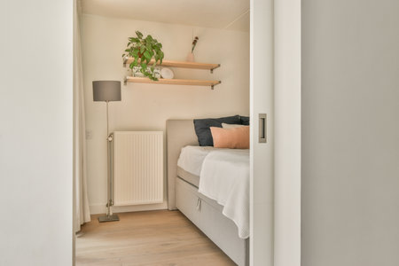 Home interior design of bedroom with bed and wooden wardrobe placed in corner near window in modern...