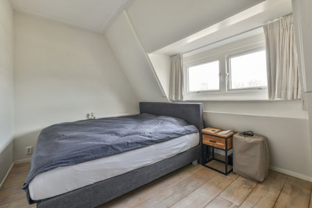 Home interior design of bedroom with bed and wardrobe placed in corner near window in modern...
