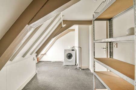 Interior of modern bright laundry room with white walls and dark reflect floor