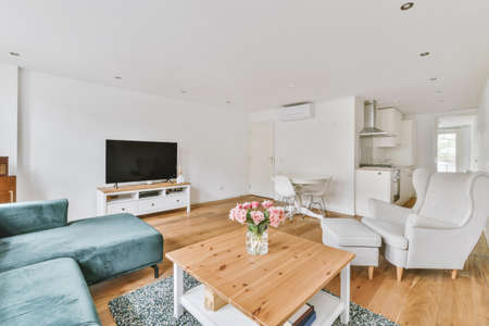 Contemporary minimalist style interior design of light studio apartment with wooden table and chairs...