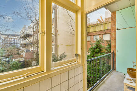 Narrow brick balcony with metal railings and door