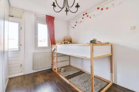 Interior of white room with baby crib in daylight
