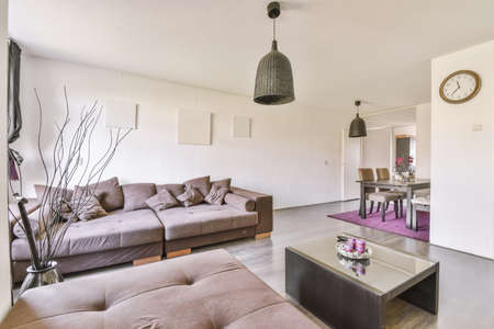 Contemporary minimalist style interior design of light studio apartment with wooden table and chairs...