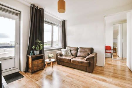 Contemporary minimalist style interior design of light studio apartment with wooden table and chairs...