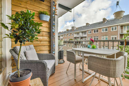 Sitting area in balcony with comfortable furniture around beautiful viewの写真素材