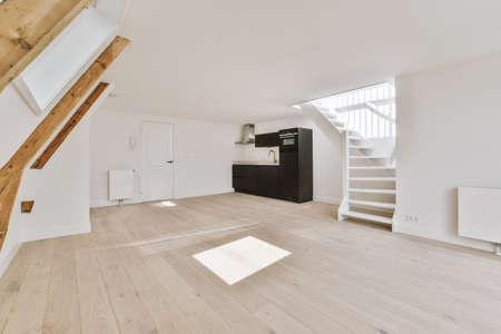 Interior of empty white kitchen with windows and wooden parquet floorの写真素材