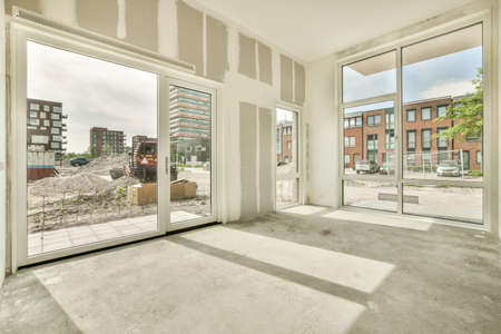 Interior of empty white kitchen with windows and wooden parquet floor