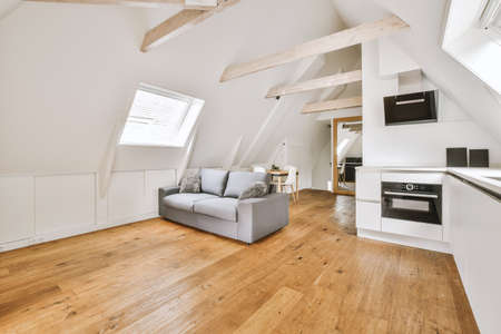 Contemporary minimalist style interior design of light studio apartment with wooden table and chairs...