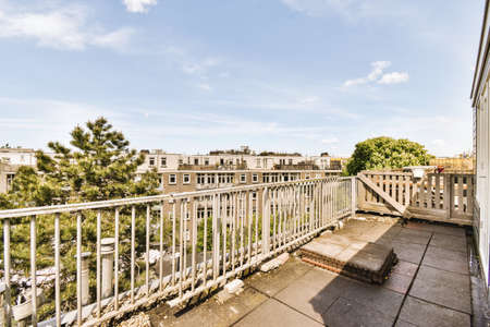 Narrow brick balcony with metal railings and doorの写真素材