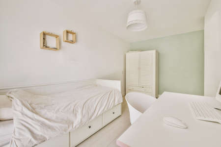 Home interior design of bedroom with bed and wooden wardrobe placed in corner near window in modern...
