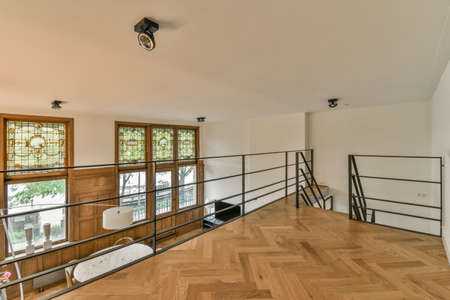 Comfortable sofa with cushions placed against light wall with TV and decorations in modern loving roomの写真素材