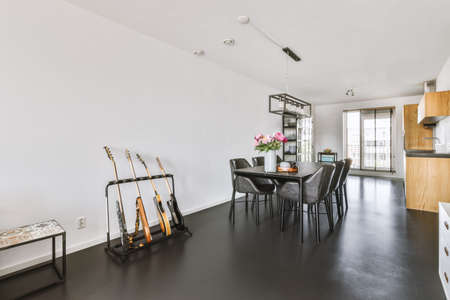 Contemporary minimalist style interior design of light studio apartment with wooden table and chairs...