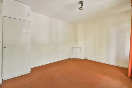 Interior of empty modern apartment with geometric design with entrance door and white walls and...