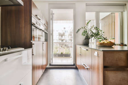 Modern minimalist style interior design of studio apartment with open white kitchen and dining zone...