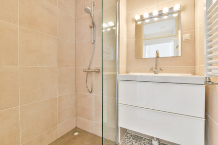 Sinks with mirrors and shower box with glass door in modern bathroom with white tiled walls
