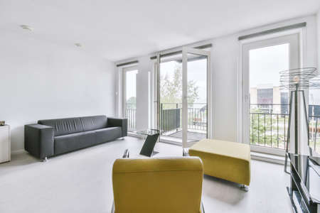 Contemporary minimalist style interior design of light studio apartment with wooden table and chairs...