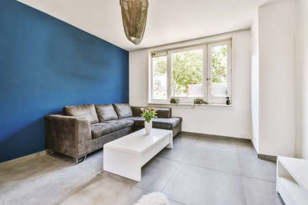 Contemporary minimalist style interior design of light studio apartment with wooden table and chairs...