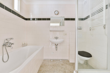 Flush toilet and shower cabin with glass partition and curtain located near sink and shelf with...