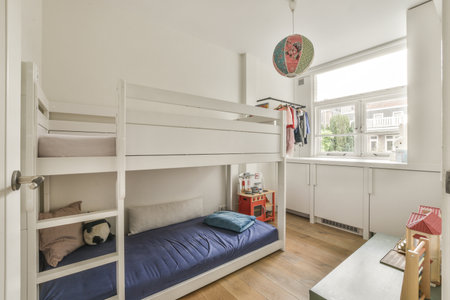 Interior of modern kid bedroom with bunk bed and shelves with various toys at home