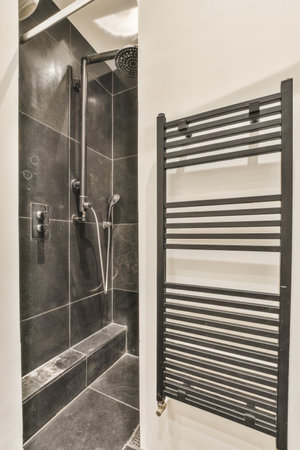 Shower faucets attached to tiled wallの写真素材