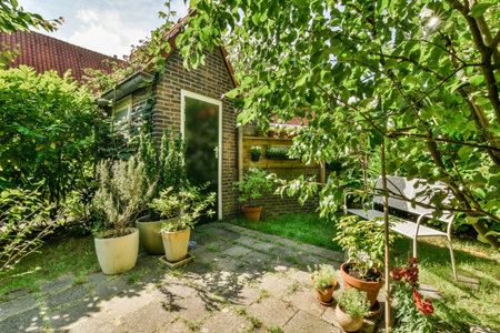 Neat powerful patio with sitting area and small garden near wooden fence