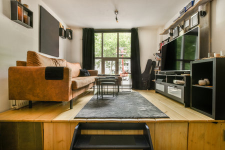 Stylish home interior design of spacious living room with large windows and white walls furnished with comfy couch and table on carpet on parquet floorの写真素材