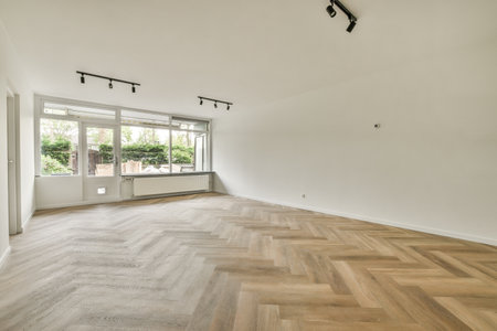 Plastic window and radiator on white wall in empty light room at homeの写真素材