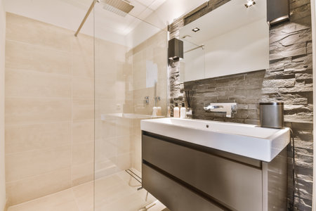 Sinks with mirrors and shower box with glass door in modern bathroom with white tiled walls