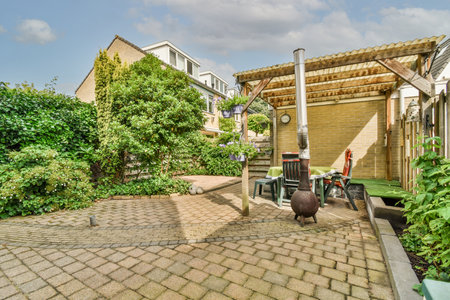 Neat powerful patio with sitting area and small garden near wooden fence