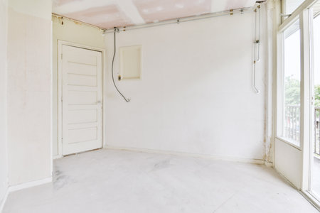 Plastic window and radiator on white wall in empty light room at homeの写真素材