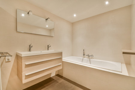 Modern home interior design of white bathroom with open bathtub and shower separated from toilet by...