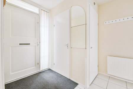 Light narrow hallway with many doors in white walls and glowing lamp over lumber floor